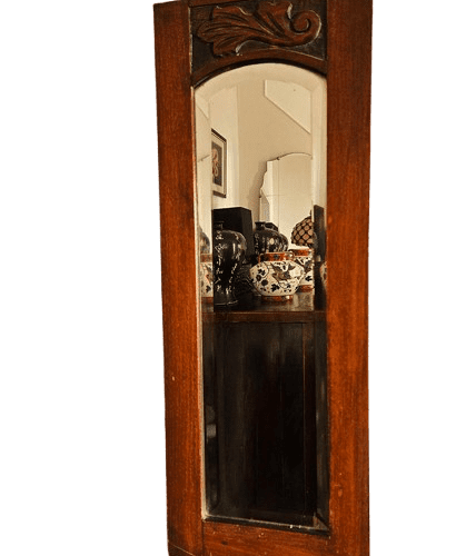 Antique narrow hall mirror with bevelled glass and carved oak frame