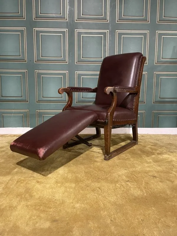 Vintage medical examination armchair with adjustable foot rest.