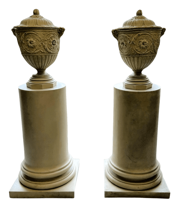 A Pair of Decorative Pedestals with Lidded Urns