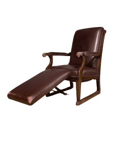 Vintage medical examination armchair with adjustable foot rest.